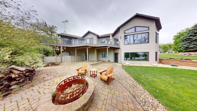 2704 Campus Ln, Albert Lea, MN 56007 - rear view of property featuring a fire pit, a patio, a lawn, and a balcony