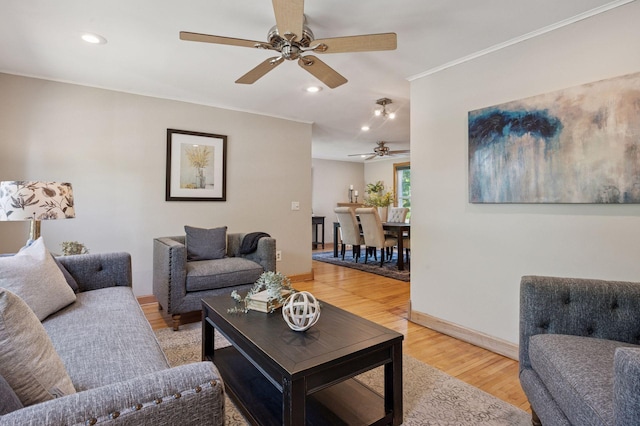 living area with ceiling fan, crown molding, light wood finished floors, recessed lighting, and baseboards