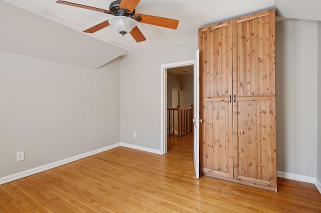 unfurnished bedroom with light wood-type flooring, baseboards, and ceiling fan