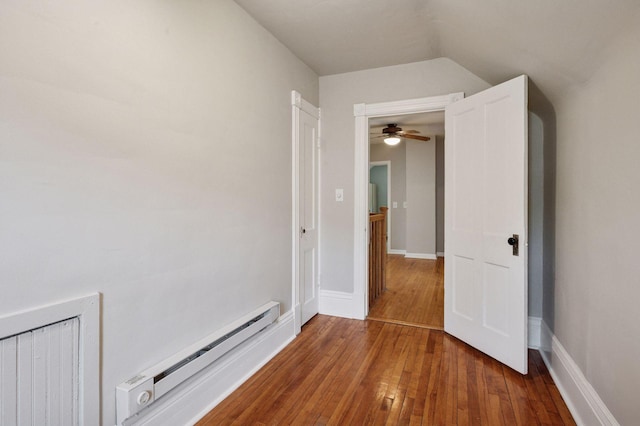 unfurnished bedroom featuring a baseboard radiator and hardwood / wood-style floors