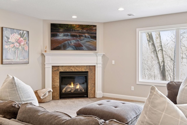 living area featuring a high end fireplace, recessed lighting, and carpet