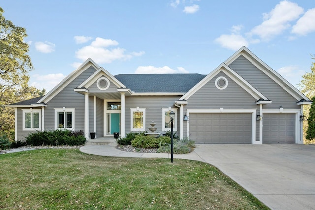 view of front of house featuring a front lawn, driveway, a shingled roof, and a garage