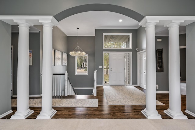 entryway featuring wood finished floors, baseboards, and ornamental molding