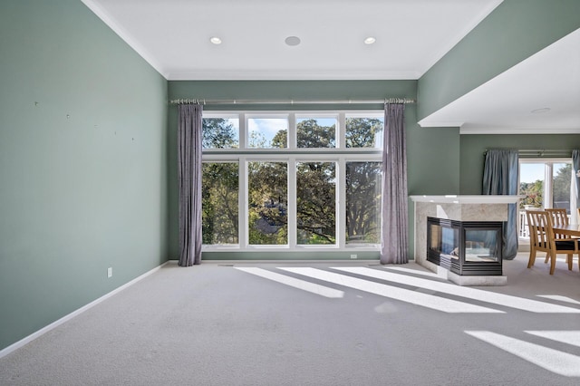 unfurnished living room with carpet flooring, crown molding, baseboards, a high end fireplace, and recessed lighting