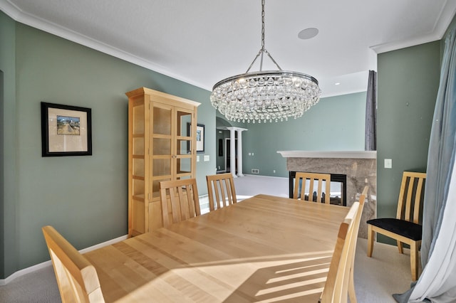 dining area with ornamental molding, carpet flooring, an inviting chandelier, and a multi sided fireplace