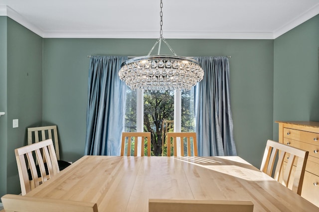 dining area featuring ornamental molding and an inviting chandelier