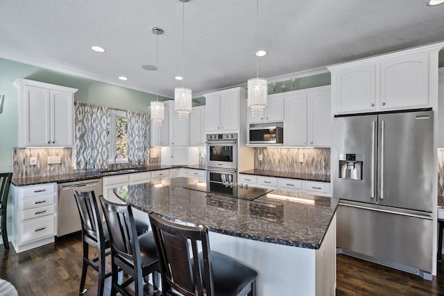 kitchen featuring a sink, white cabinetry, dark wood-type flooring, backsplash, and stainless steel appliances