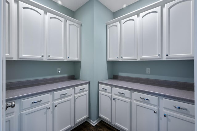 clothes washing area featuring dark wood finished floors