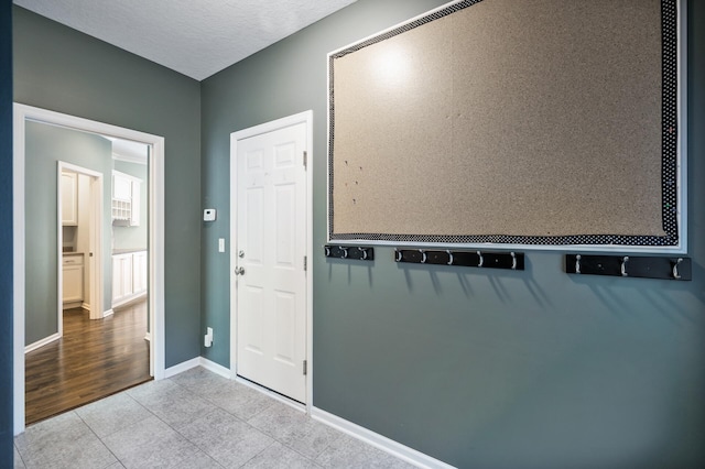 foyer featuring tile patterned flooring and baseboards