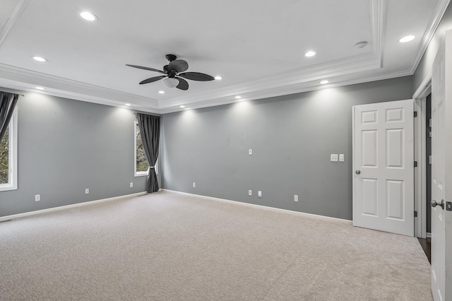 carpeted spare room with a ceiling fan, a raised ceiling, ornamental molding, and recessed lighting