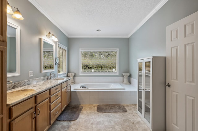 full bath featuring double vanity, a bath, a textured ceiling, and a sink