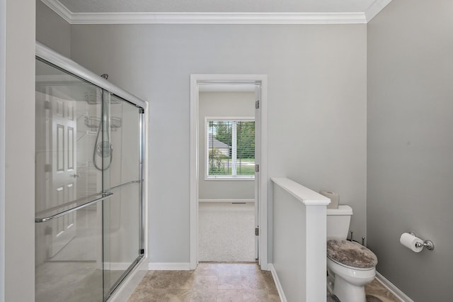 full bathroom with a shower stall, toilet, and crown molding