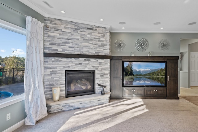 unfurnished living room with a tiled fireplace, carpet floors, crown molding, visible vents, and baseboards