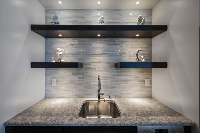 kitchen with a sink, open shelves, tasteful backsplash, and recessed lighting