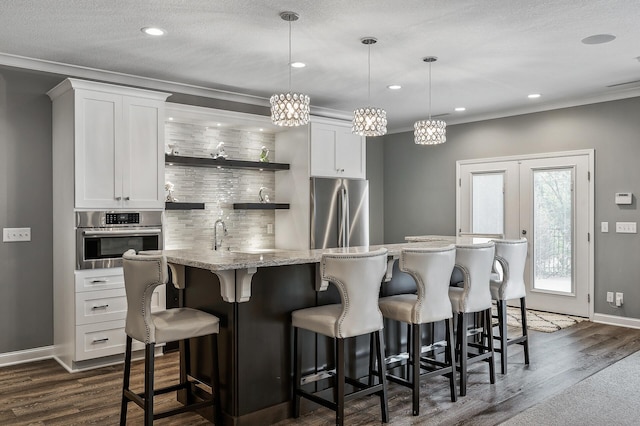 kitchen with open shelves, white cabinets, appliances with stainless steel finishes, decorative backsplash, and dark wood-style floors