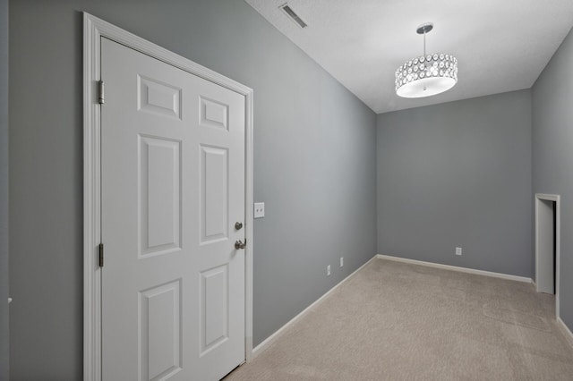 interior space with light carpet, baseboards, and visible vents