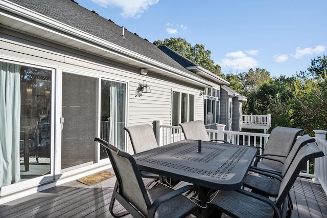 wooden terrace featuring outdoor dining space