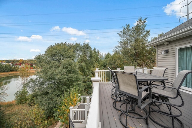 deck featuring a water view and outdoor dining area