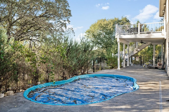 view of swimming pool with a fenced in pool, fence, a patio, ceiling fan, and stairs