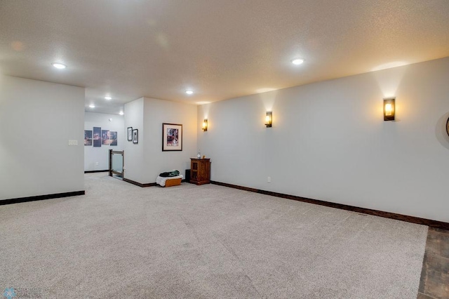 unfurnished living room featuring baseboards, carpet floors, and recessed lighting