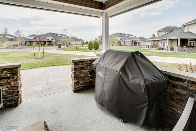 view of patio / terrace featuring covered porch, a grill, and a residential view
