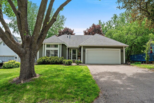 95 Olympic Cir, Chanhassen, MN 55317 - single story home featuring a garage, asphalt driveway, a front lawn, and a shingled roof