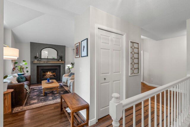 95 Olympic Cir, Chanhassen, MN 55317 - living room featuring wood finished floors, a brick fireplace, and lofted ceiling