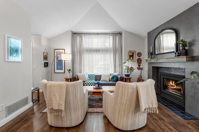 95 Olympic Cir, Chanhassen, MN 55317 - living area with vaulted ceiling, a tile fireplace, wood finished floors, and baseboards