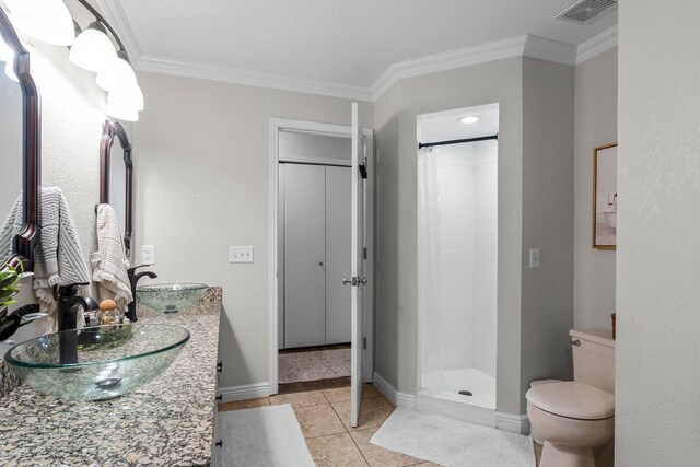 95 Olympic Cir, Chanhassen, MN 55317 - full bath featuring ornamental molding, a tile shower, toilet, double vanity, and baseboards