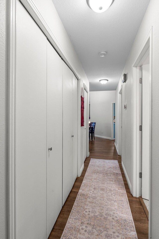95 Olympic Cir, Chanhassen, MN 55317 - hallway featuring dark wood-type flooring and baseboards