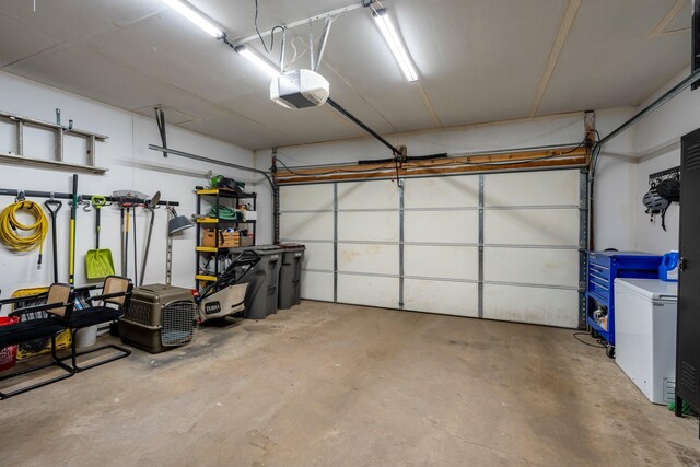 95 Olympic Cir, Chanhassen, MN 55317 - garage featuring a garage door opener and refrigerator