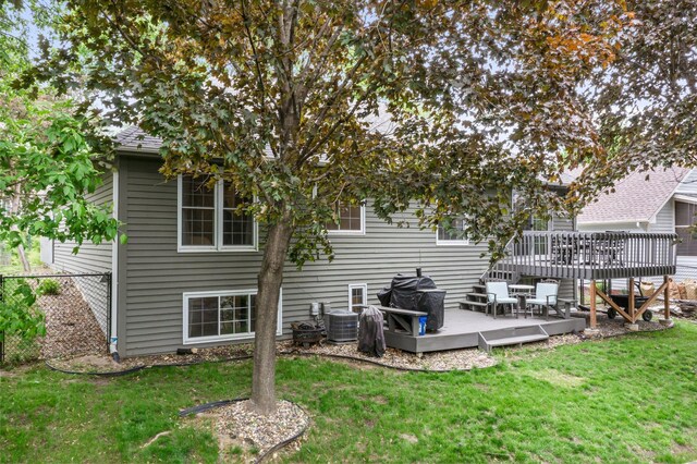 95 Olympic Cir, Chanhassen, MN 55317 - back of house with a wooden deck and central AC