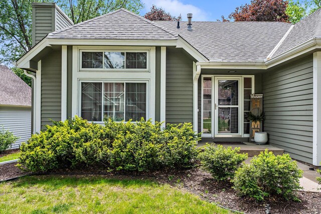 95 Olympic Cir, Chanhassen, MN 55317 - entrance to property with a chimney and a shingled roof