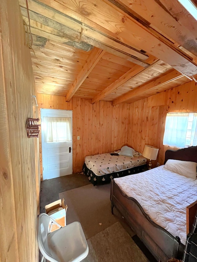 17353 Pine Dr NW, Angle Inlet, MN 56711 - carpeted bedroom featuring wooden walls, wood ceiling, and beamed ceiling