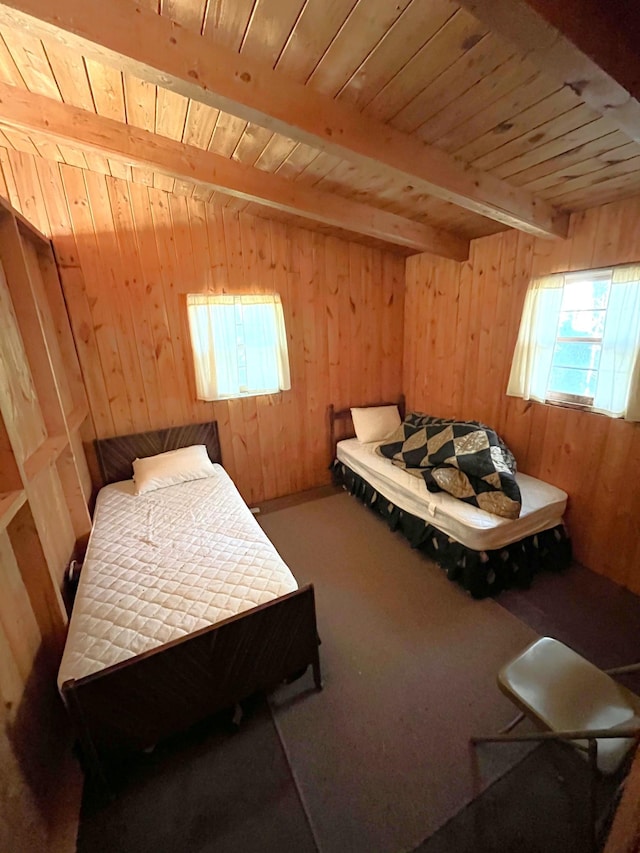 17353 Pine Dr NW, Angle Inlet, MN 56711 - carpeted bedroom featuring wood walls, wooden ceiling, and beam ceiling