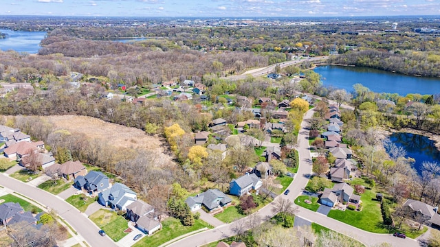 bird's eye view featuring a water view, a forest view, and a residential view