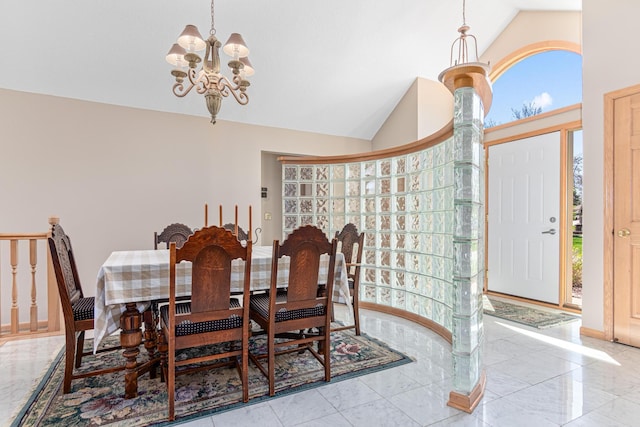 dining area featuring a chandelier, lofted ceiling, a wealth of natural light, and marble finish floor