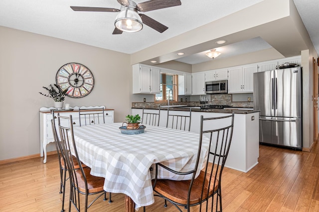 dining room with light wood-type flooring, baseboards, ceiling fan, and recessed lighting