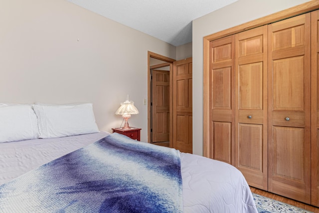 bedroom with a closet and wood finished floors