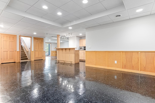 interior space with stairway, wainscoting, recessed lighting, and granite finish floor