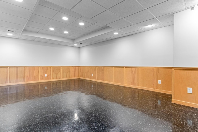 spare room with recessed lighting, a wainscoted wall, and granite finish floor