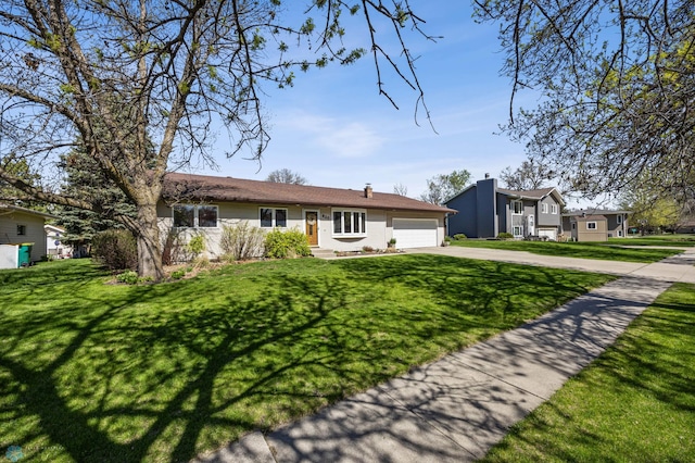 view of front facade with driveway, a garage, and a front lawn