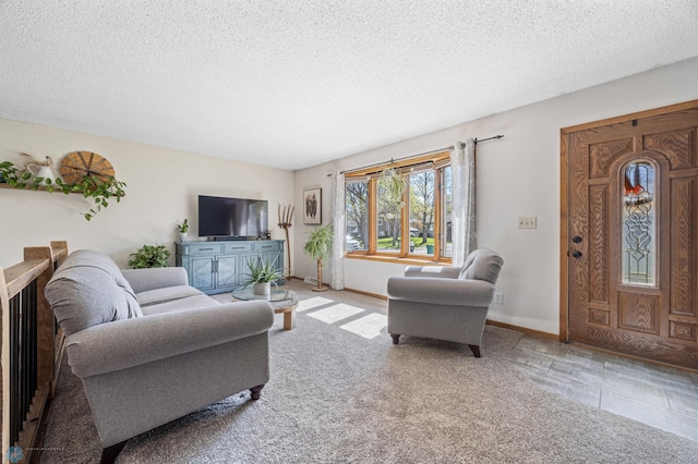 living area featuring a textured ceiling and baseboards