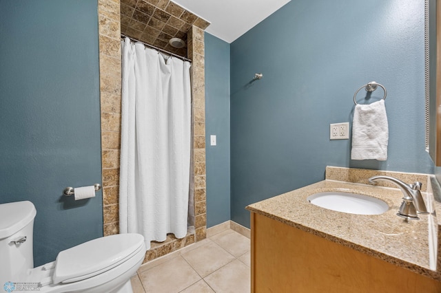 full bathroom with toilet, tile patterned flooring, a tile shower, and vanity