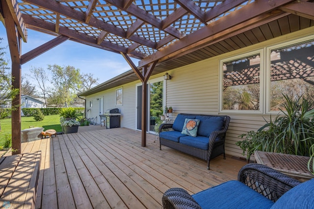 wooden deck featuring a pergola, a grill, a yard, and an outdoor hangout area