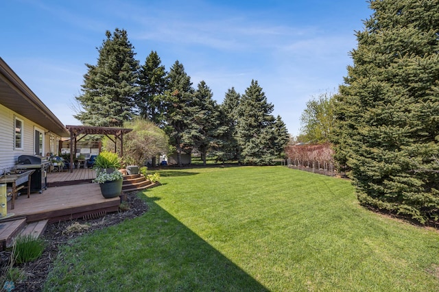 view of green lawn with a wooden deck and a pergola