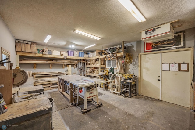 basement featuring a workshop area and a textured ceiling
