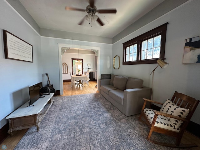 911 8th St N, Fargo, ND 58102 - living area featuring wood finished floors, a ceiling fan, and a chandelier