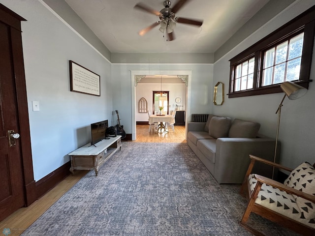 911 8th St N, Fargo, ND 58102 - living area featuring baseboards, ceiling fan with notable chandelier, and wood finished floors