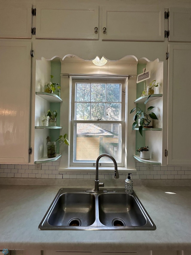 911 8th St N, Fargo, ND 58102 - kitchen featuring open shelves, white cabinetry, and a sink